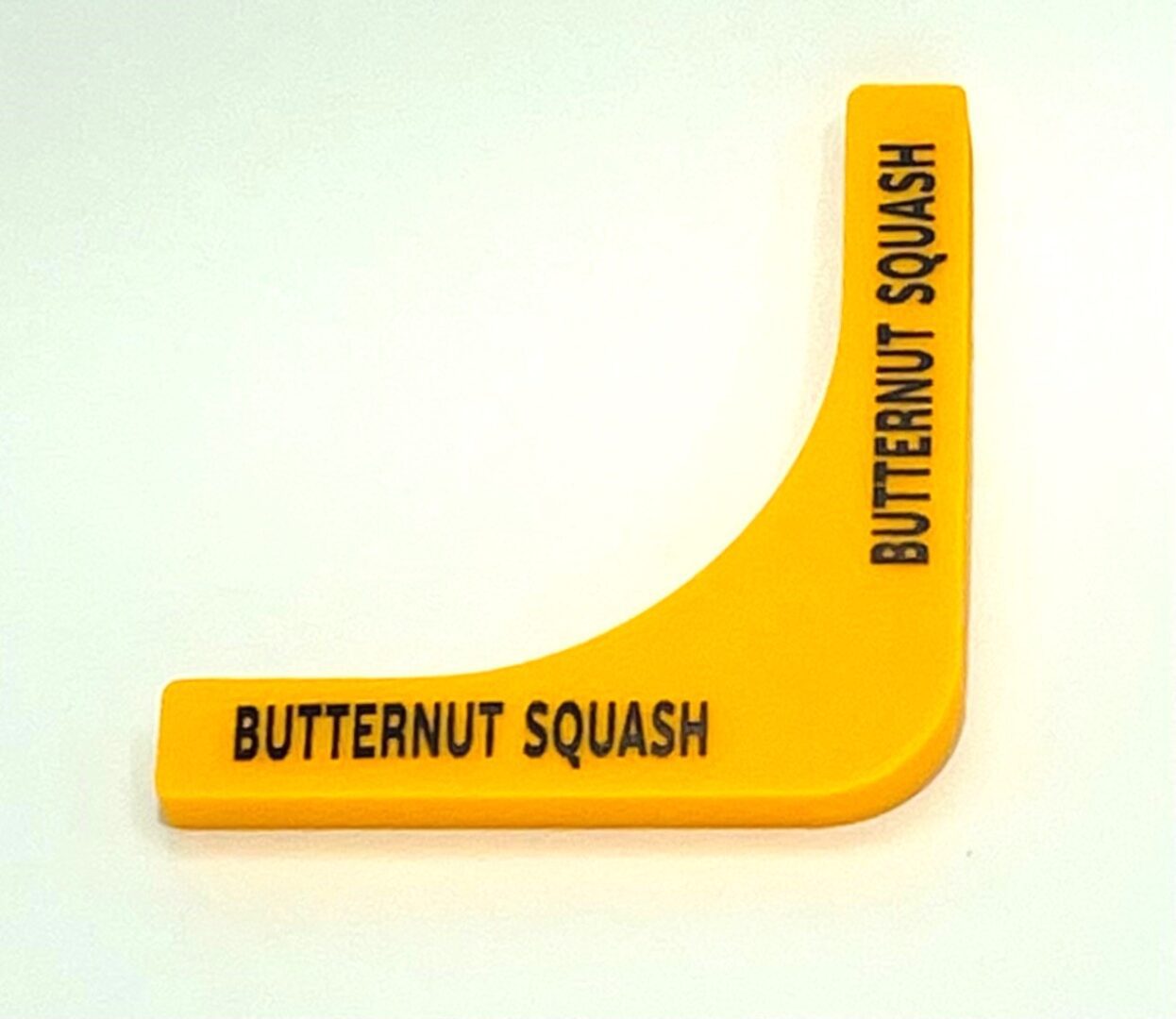 A yellow squash wedge with the words butternut squash written on it.