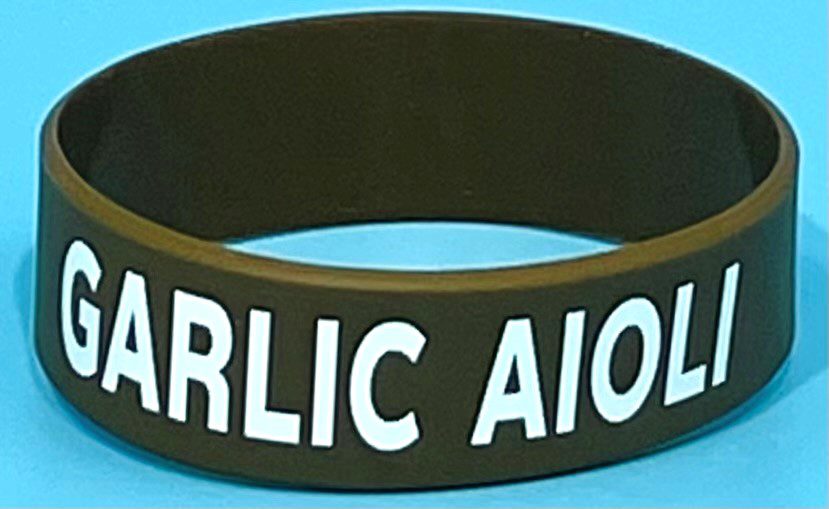 A black bracelet with the words garlic aioiia on it.