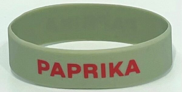 A close up of the wrist band with paprika written on it