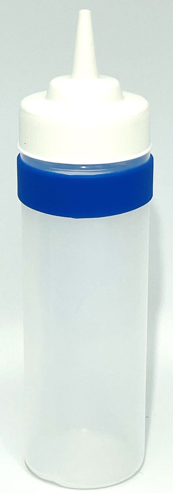 A plastic container with blue lid on top of a table.