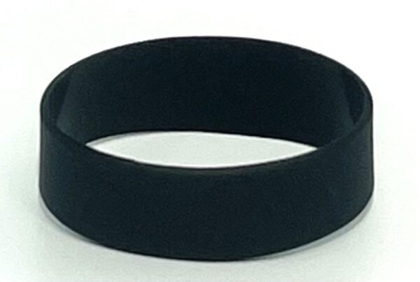 A black rubber bracelet is shown on top of the floor.