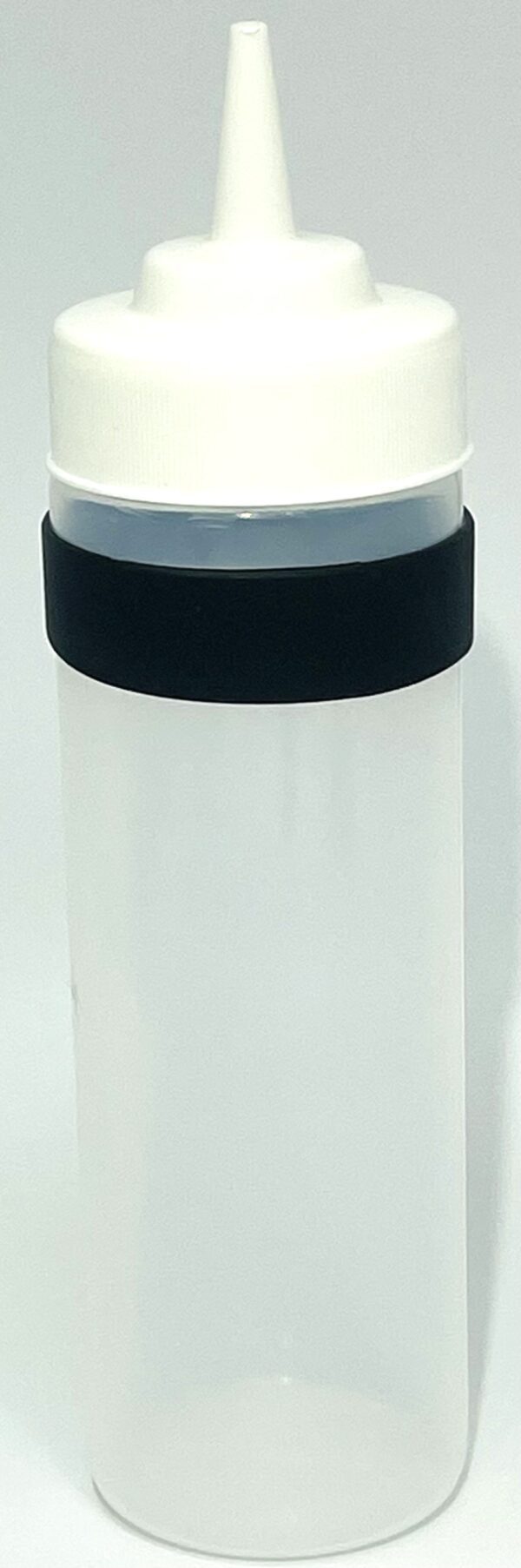 A plastic container with black lid on top of white surface.