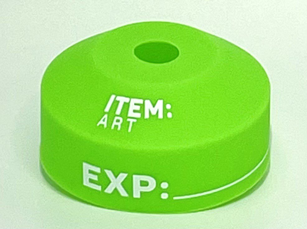 A green item : art cap with the word " exp ".