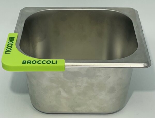 A metal bowl with broccoli on it.