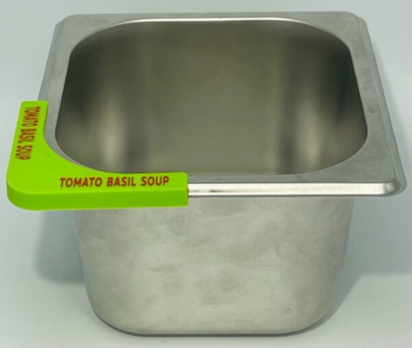 A metal bowl with a green sticker on it.