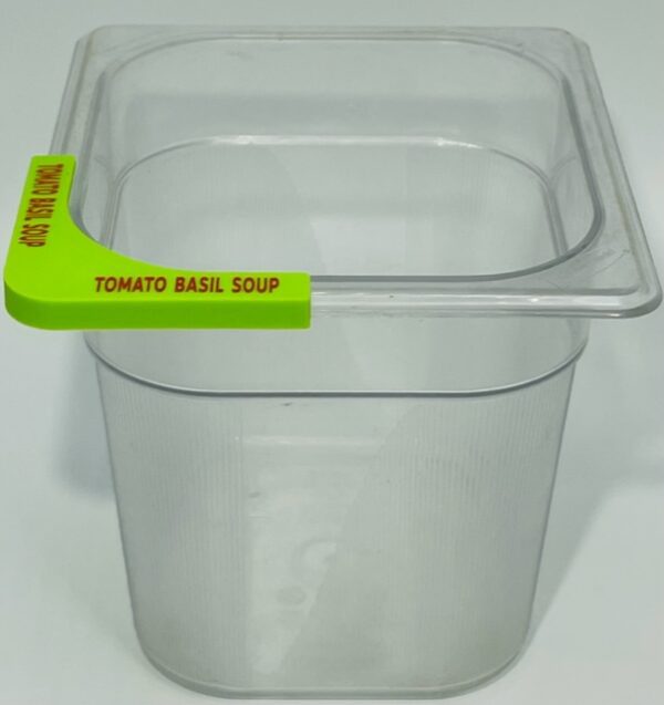 A plastic container with a green handle and a yellow sticker.