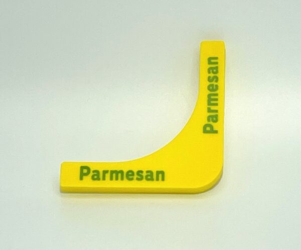 A yellow plastic object with the word parmesan written on it.