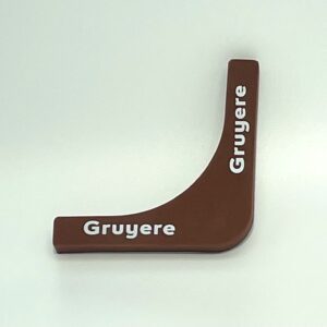 A brown wooden object with the word gruyere written on it.