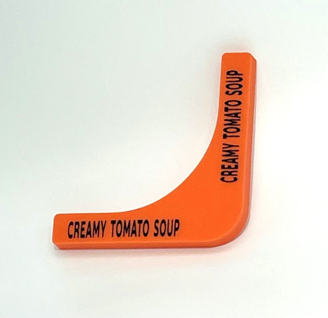 A orange corner marker with the words " creamy tomato soup ".