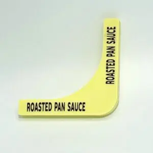 A yellow plastic sticker with the words " roasted pan sauce ".