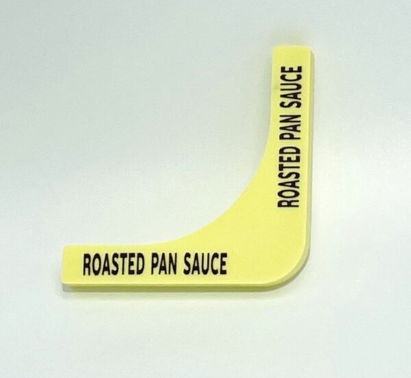 A yellow plastic sticker with the words " roasted pan sauce ".