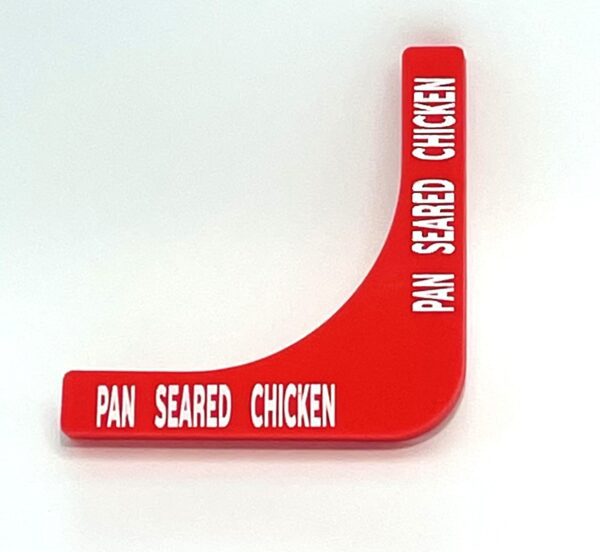 A red sign with the words pan seared chicken written on it.