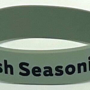 A green wristband with the words irish seasoning written on it.