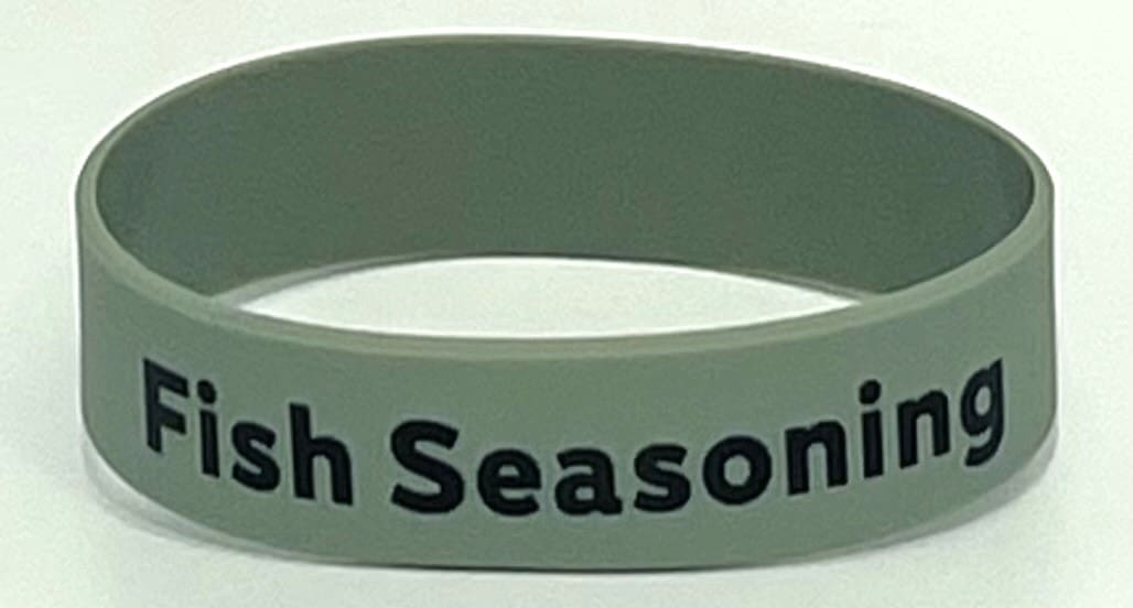 A green wristband with the words irish seasoning written on it.