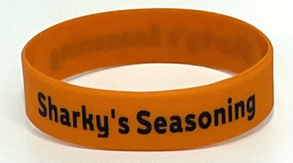 A close up of a wristband with the words " sparky 's season."