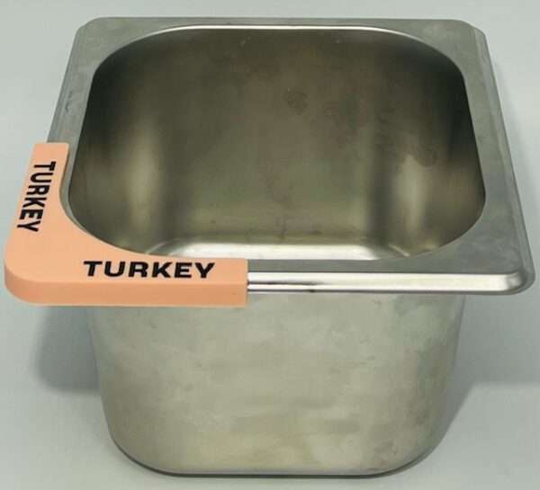 A turkey in a metal pan with the word " turkey " written on it.