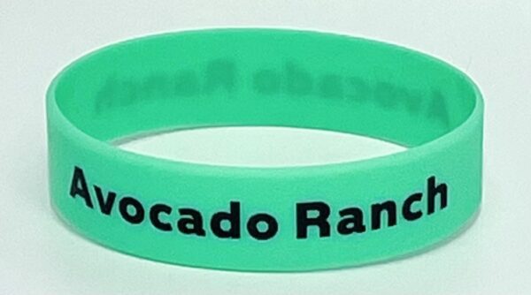 A green bracelet with the words " avocado ranch ".