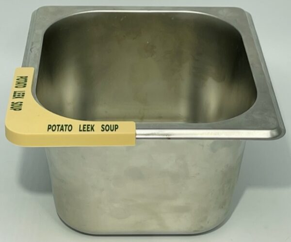 A metal pot with the label potato leek soup.