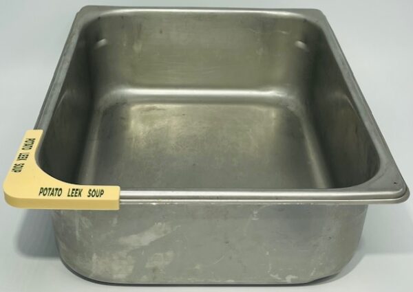 A metal pan with the label " less soup ".