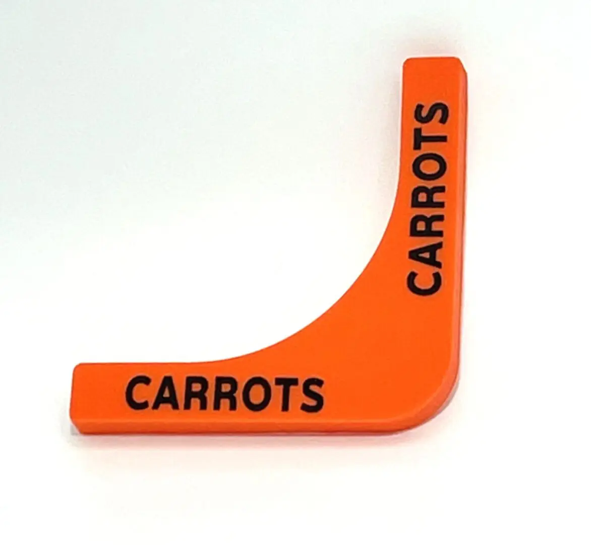 A carrot shaped plastic sign with the word carrots written on it.