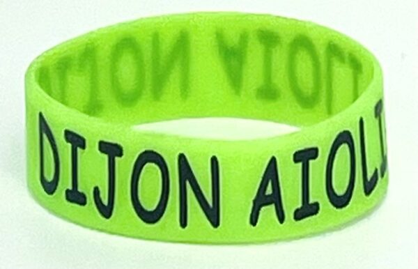 A neon green bracelet with the name aijon aigon.