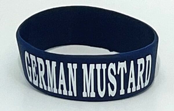 A close up of the wristband with german mustard written on it