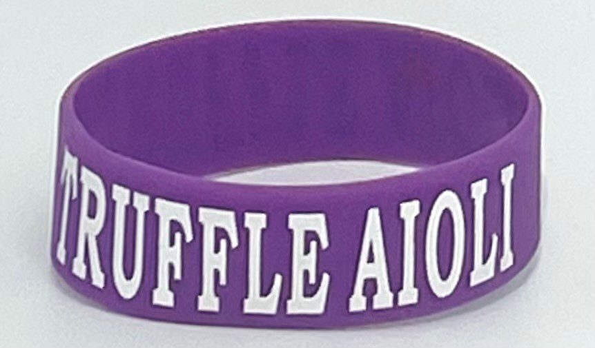 A purple bracelet with the words " ruffle aion ".