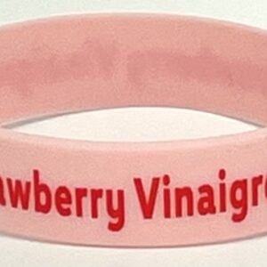 A pink bracelet with the words strawberry vinaigrete on it.