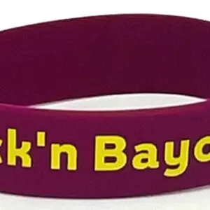 A purple wristband with the words " fuck ' n bayou ".