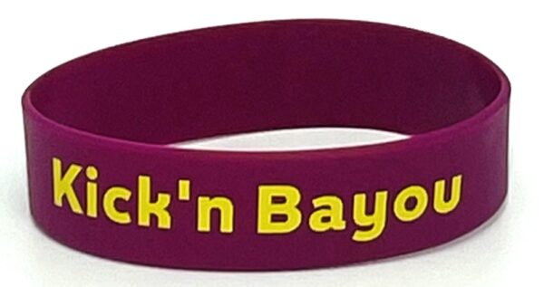 A purple wristband with the words " fuck ' n bayou ".