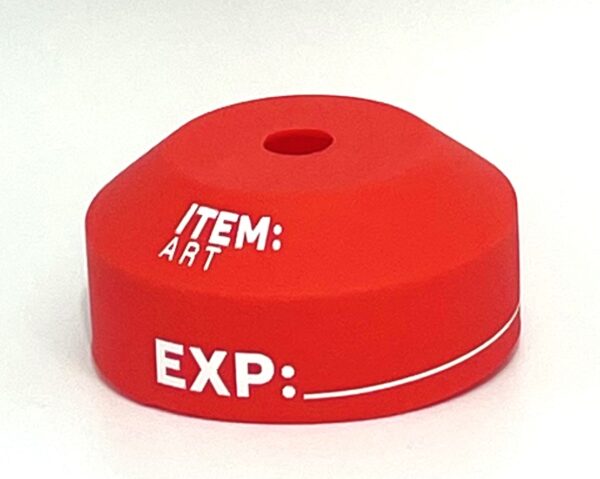 A red item marker sitting on top of a table.