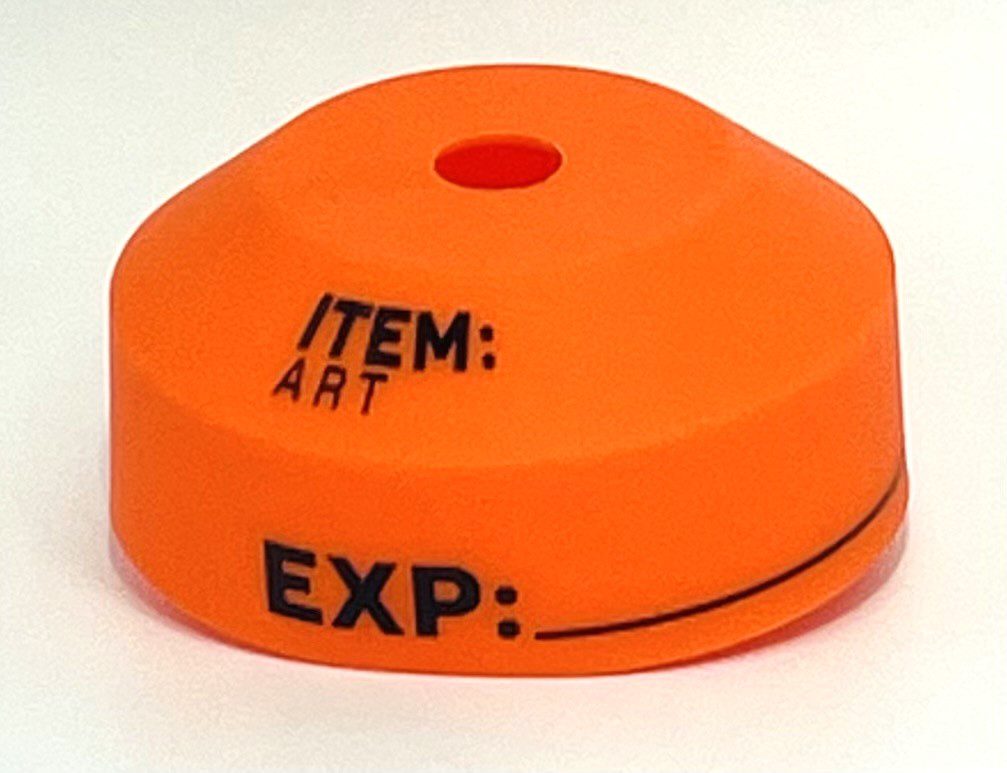 A orange object with black writing on it.