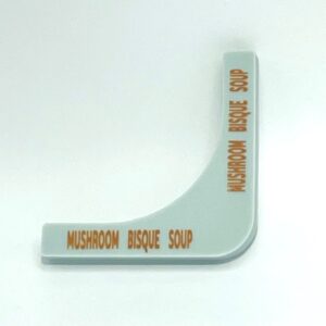 A white corner sign with the words mushroom bisque soap on it.