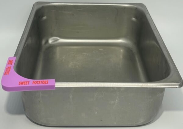 A metal pan with pink label on it.