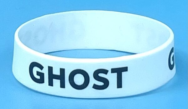 A white wristband with the word " ghost " written on it.