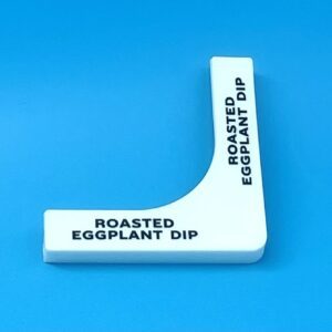 A white plastic object with the words " roasted eggplant dip ".