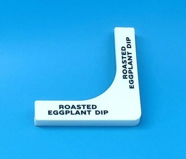 A white plastic object with the words " roasted eggplant dip ".