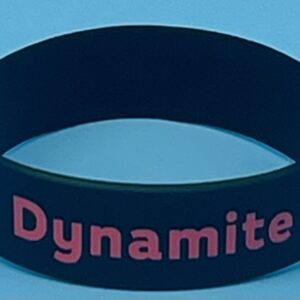 A black wristband with the word dynamite written on it.