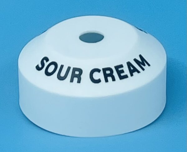 A white container with sour cream written on it.