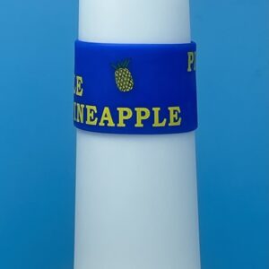 A blue and yellow pineapple bracelet on a white candle.