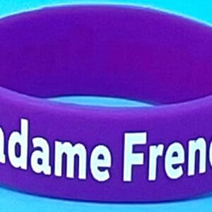 A purple wristband with the word madame french written on it.