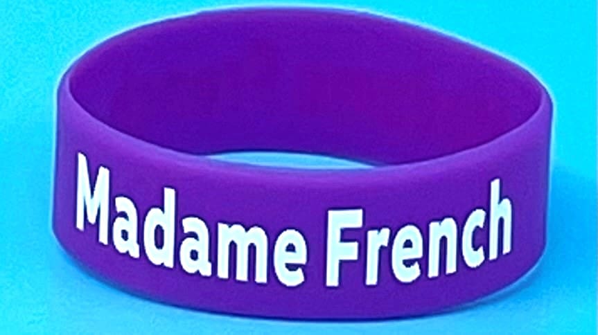 A purple wristband with the word madame french written on it.