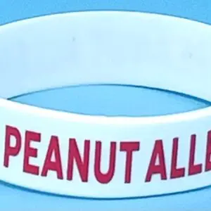 A peanut allergy wristband is shown on the table.