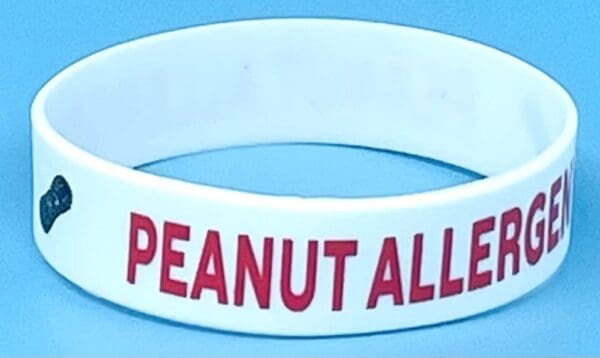 A peanut allergy wristband is shown on the table.