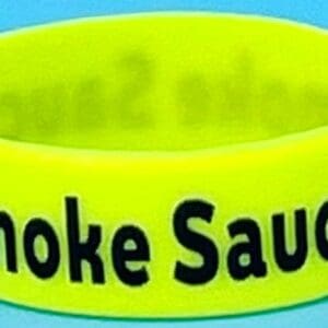 A neon yellow smoke sauce wristband with the words " smoke sauced ".