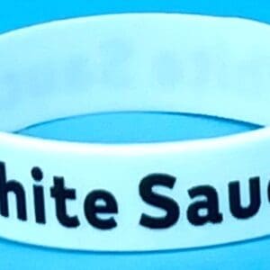 A white bracelet with the words " white sauce ".