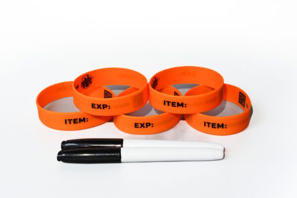 A group of orange bracelets with items written on them.