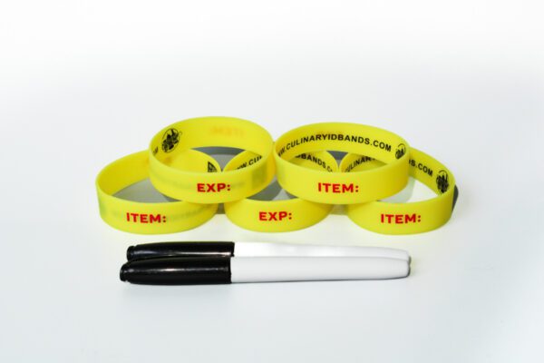 A group of yellow bracelets with items written on them.