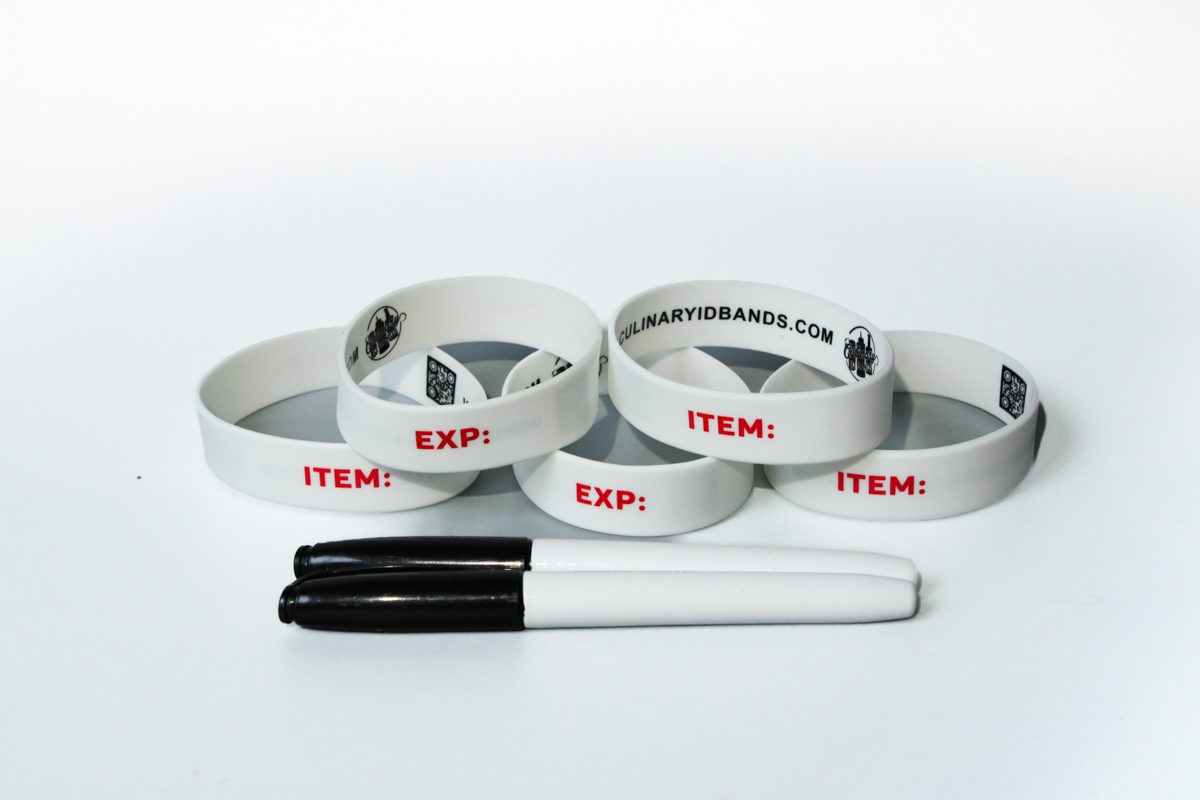 A group of white bracelets with items written on them.