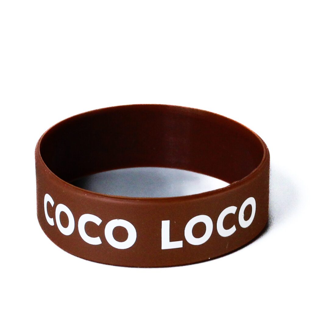 A brown rubber bracelet with the word coco loco written on it.